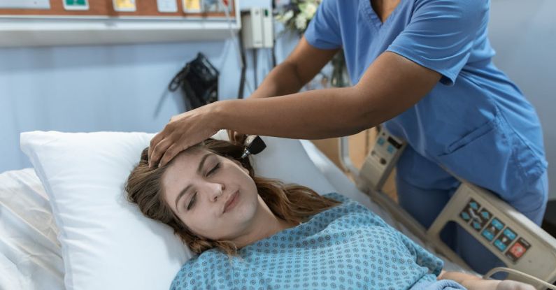 Recovery Tools - Crop African American female doctor with professional equipment doing examination of ear of woman lying on bed in hospital ward