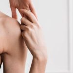 Home Workouts - Young Woman in Black Sports Bra and Black Leggings Doing Home Workout