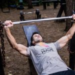 Bench Press - Man in Grey Shirt and Black Bottom Lifting Barbell