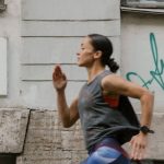 Cardio Workouts - A Side View of a Woman Jogging on the Street