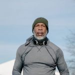 Winter Fitness - Mature Man with a Gray Beard Running in City