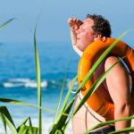 Hot Weather - Orange Safety Ring on Man Shoulder Near Body of Water