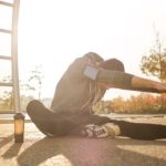 Fall Fitness - Flexible sportsman stretching on sports ground
