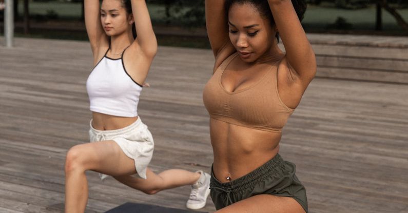 Power Yoga - Diverse women doing Crescent Lunge pose together