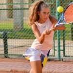 HIIT - Sporty female playing tennis on court