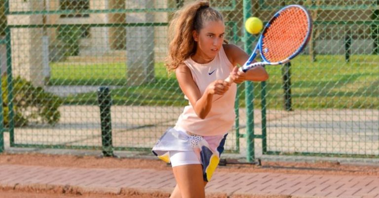 HIIT - Sporty female playing tennis on court