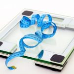 Weight Loss - Blue Tape Measuring on Clear Glass Square Weighing Scale