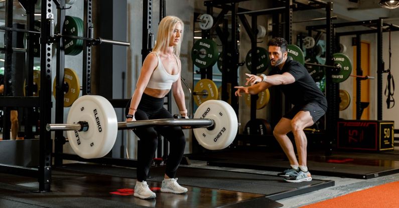 Deadlift - Woman Holding Barbell at Gym